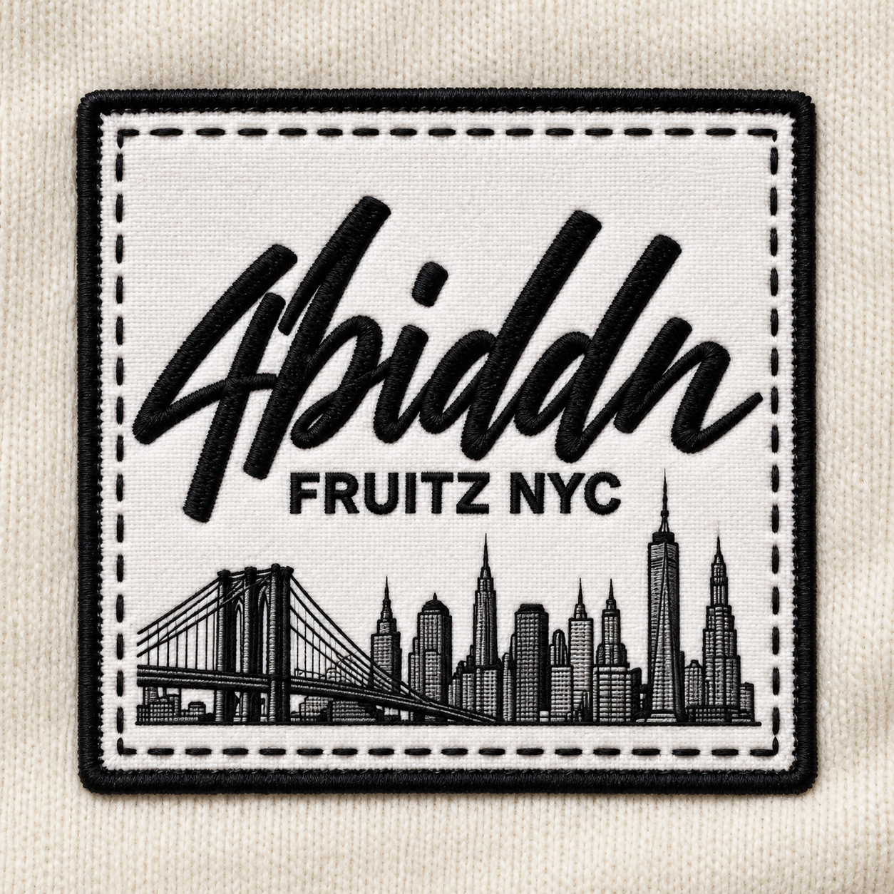 Close-up design visualization of a white 4biddn FRUITZ NYC patch with black stitching, Brooklyn Bridge and NYC skyline